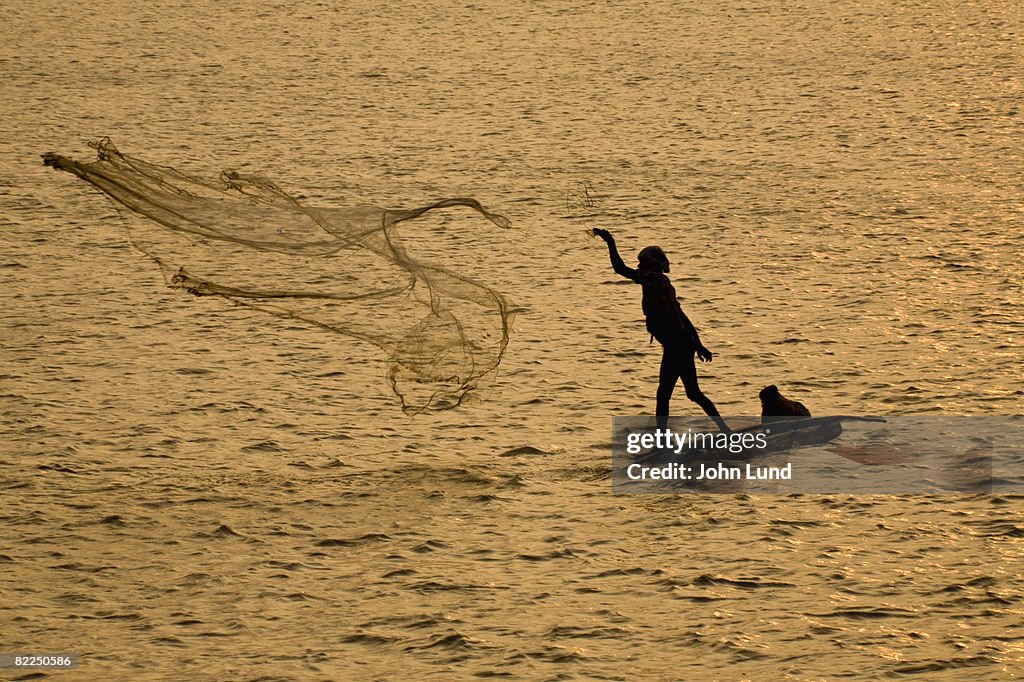 Fisherman casting net in Cochin, India