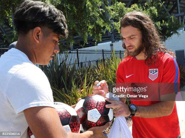 Graham Zusi of United States signs autographs for the fans after the United States National Team training session prior to the final match against...