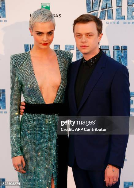 British model and actress Cara Delevingne and US actor Dane DeHaan pose for a photograph upon arrival for the pre-premiere of the film "Valerian and...
