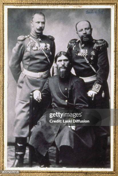 Grigori Rasputin, Russian mystic and friend of the family of Tsar Nicholas II of Russia, seated between prince Putiatin and colonel Dmitry...