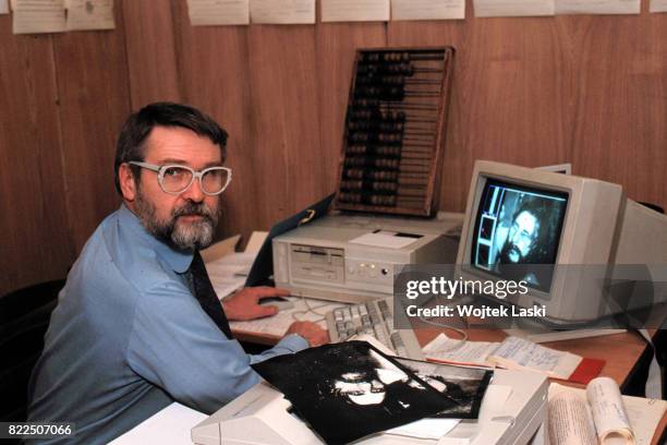 Investigation into Grigori Rasputin's death. Pictured: a Russian forensic scientist examines the pictures of Grigori Rasputin. Saint Petersburg,...