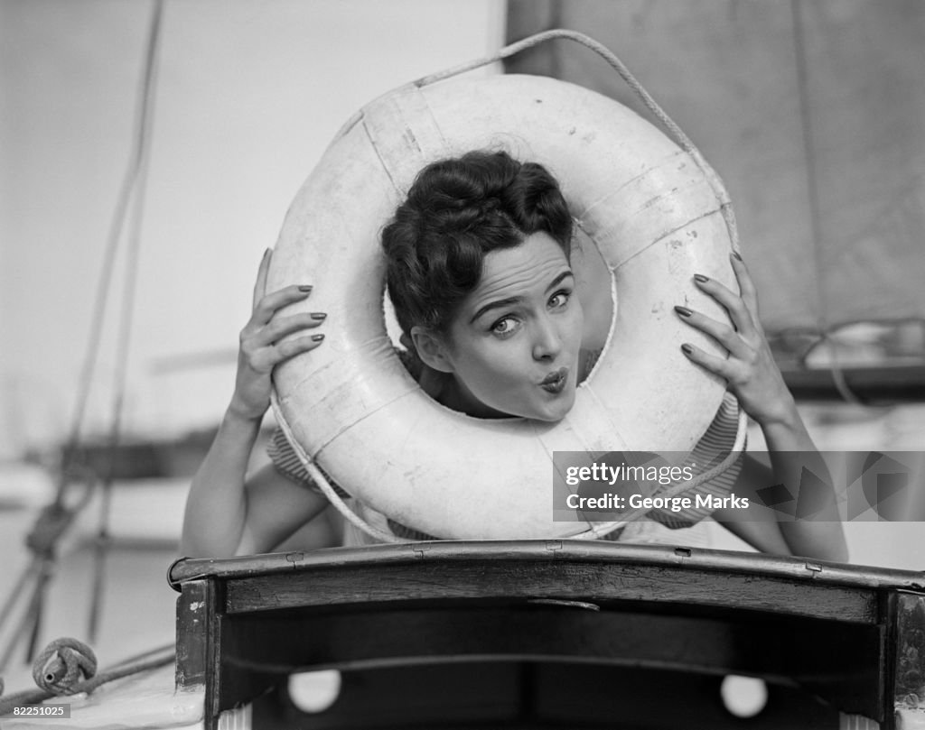 Young woman posing with head in life belt