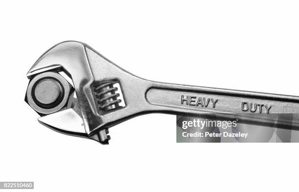 heavy duty adjustable spanner tightening/loosening metal nut on bolt - adjustable wrench ストックフォトと画像