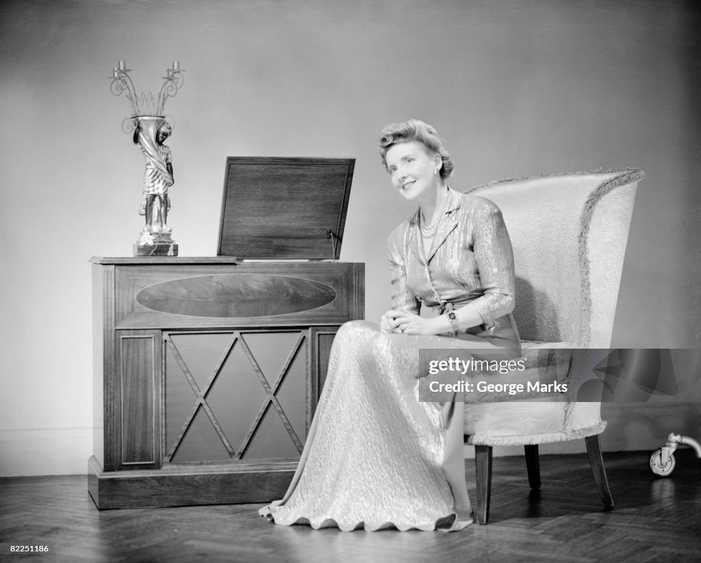 Mature woman sitting on chair, portrait