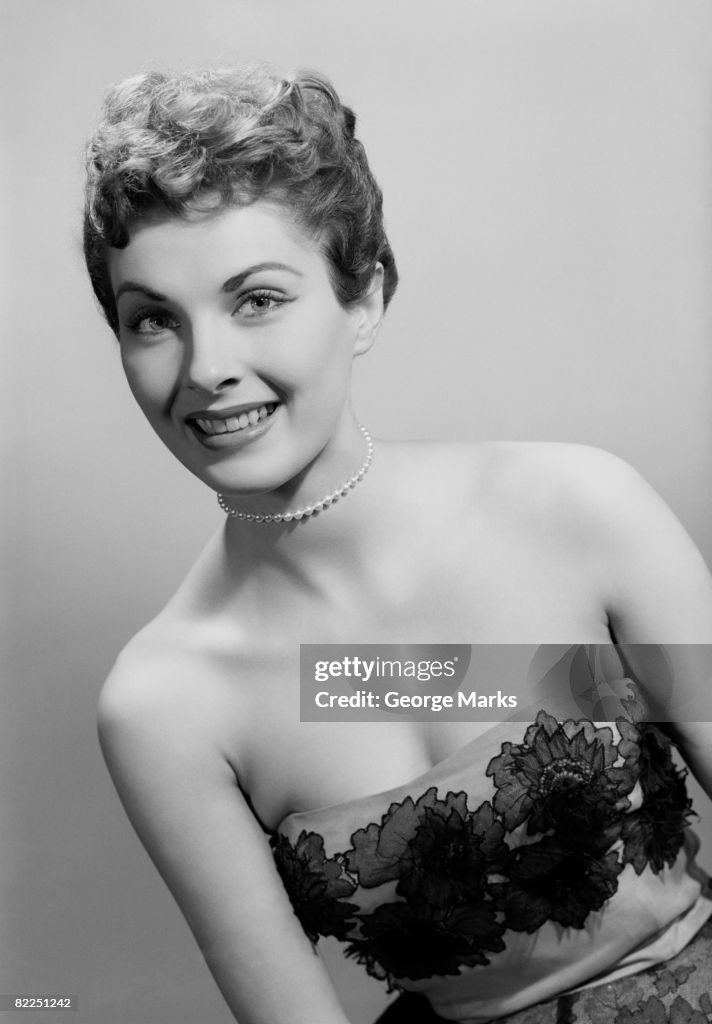 Studio portrait of mid adult woman