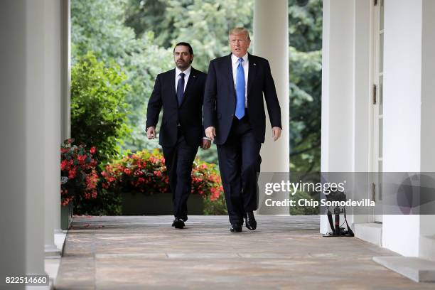 President Donald Trump and Lebanese Prime Minister Saad Hariri walk into the Rose Garden for a joint news conference at the White House July 25, 2017...