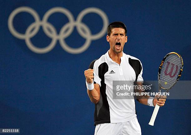Serbia's Novak Djokovic reacts to a winning match point against Robby Ginepri of the US during the men's singles first round tennis match at the 2008...