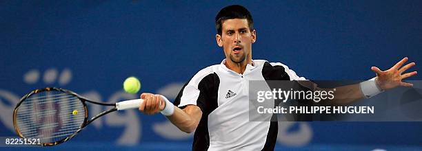 Serbia's Novak Djokovic hits a return against Robby Ginepri of the US during the men's singles first round tennis match at the 2008 Beijing Olympic...