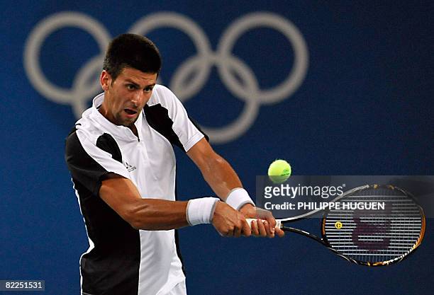 Novak Djokovic from Serbia returns against Robby Ginepri from the USA during a men's singles first round tennis match of the 2008 Beijing Olympic...