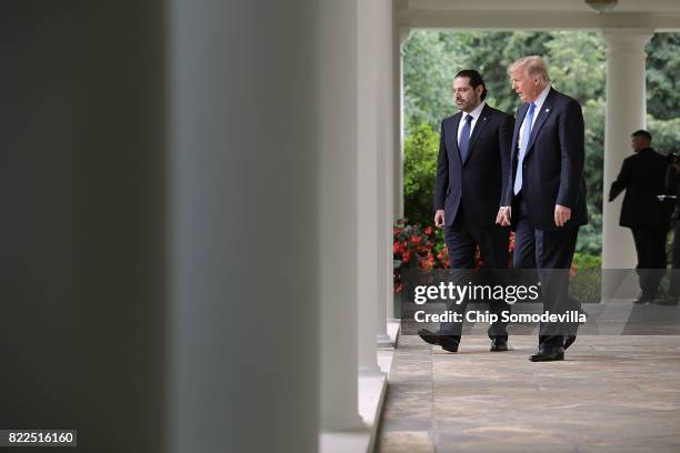 President Donald Trump and Lebanese Prime Minister Saad Hariri walk into the Rose Garden for a joint news conference at the White House July 25, 2017...