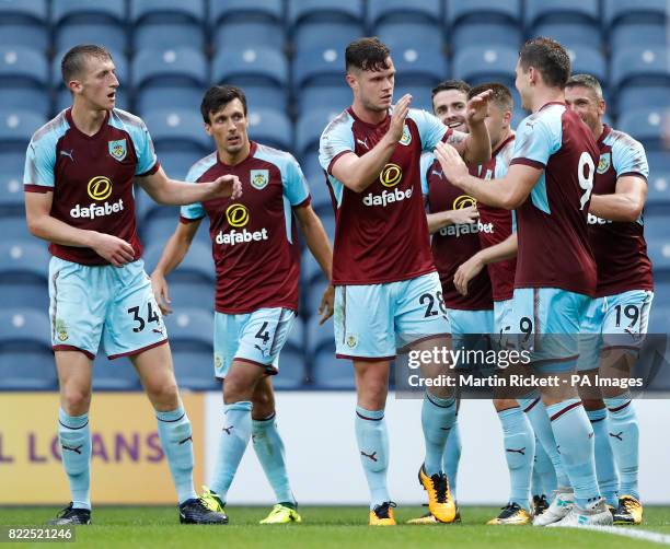 Burnley's Sam Vokes celebrates scoring his side's second goal of the game with teammates during the pre-season friendly match at Deepdale, Preston.