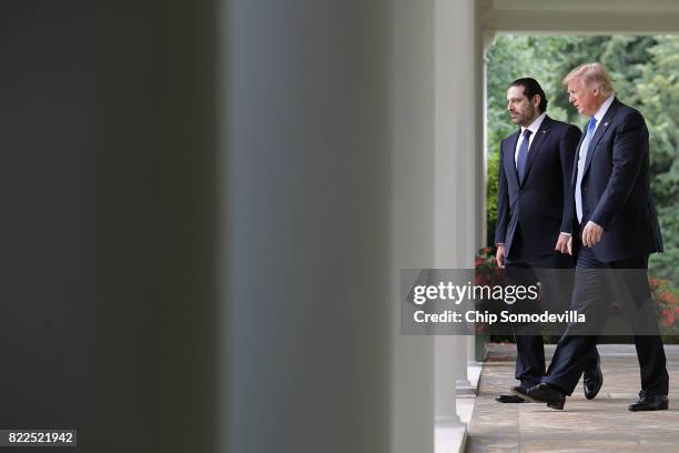 President Donald Trump and Lebanese Prime Minister Saad Hariri walk into the Rose Garden for a joint news conference at the White House July 25, 2017...