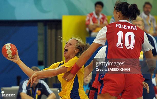 Johanna Ahlm of Sweden vies with Elena Polenova of Russia during their 2008 Olympics Games women's Handball match on August 11 in Beijing. AFP PHOTO...