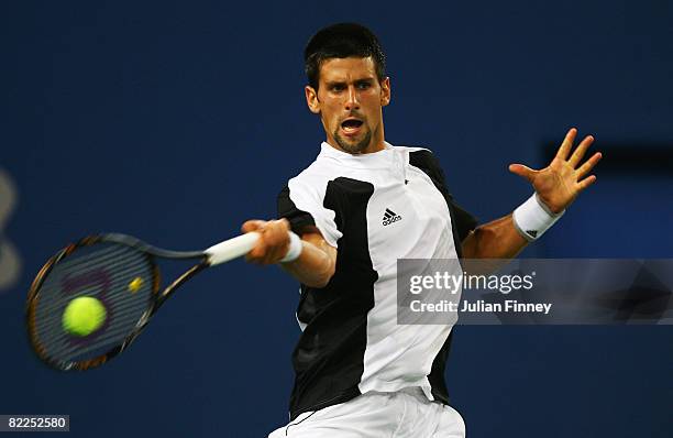 Novak Djokovic of Serbia plays a forehand to Robby Ginepri of the United States in the Men's Singles First Round match at the Olympic Green Tennis...