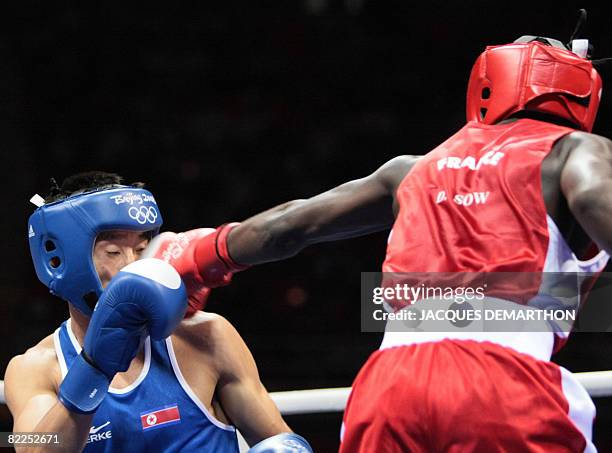 France's Daouda Sow fights against DPR of Korea's Song Guk Kim during their 2008 Olympic Games Lightweight boxing bout on August 11, 2008 in Beijing....