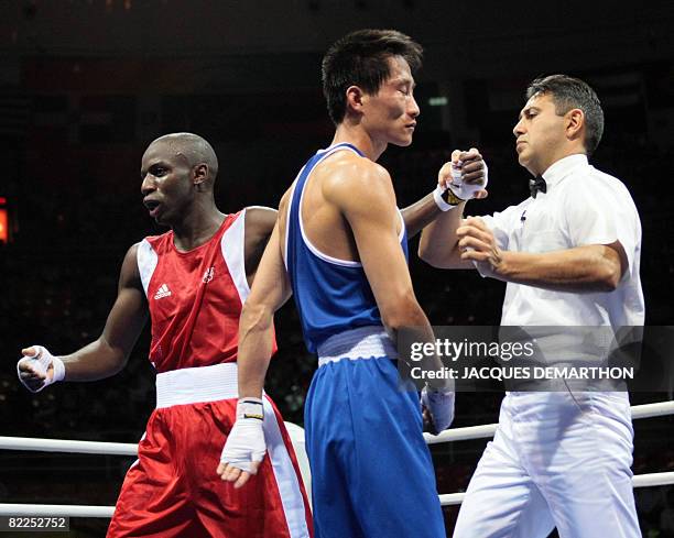 France's Daouda Sow is declared winner after defeating DPR of Korea's Song Guk Kim during their 2008 Olympic Games Lightweight boxing bout on August...
