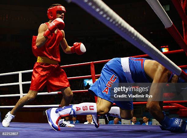 Ali Sadam of the United States is knocked down by Georgian Popescu of Romania during their men's 60kg light weight bout in the boxing event at the...