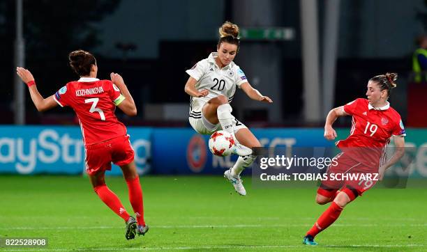 Germany's midfielder Lina Magull vies with Russia's defender Anna Kozhnikova and Russia's defender Ekaterina Morozova during the UEFA Women's Euro...