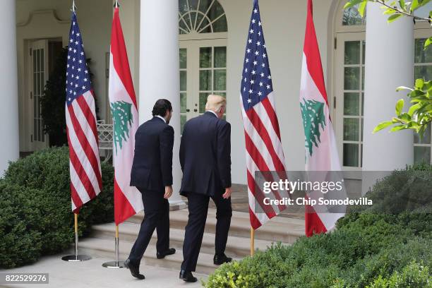 President Donald Trump and Lebanese Prime Minister Saad Hariri leave after holding a joint news conference in the Rose Garden at the White House July...