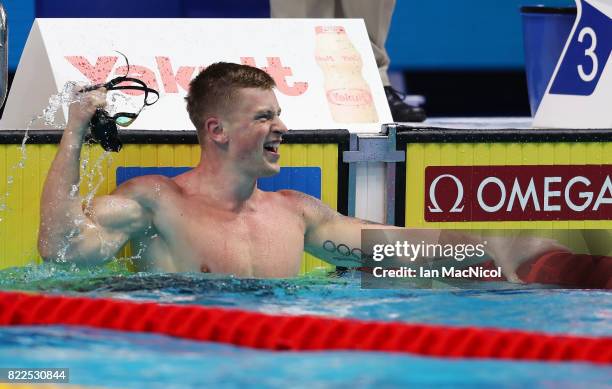 Adam Peaty of Great Britain reacts as he breaks the world record during the Mens 50m Breaststroke semi final during day twelve of the FINA World...