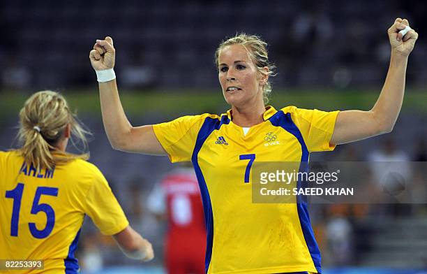 Annika Wiel Freden of Sweden celebrates scoring with teammate Johanna Ahlm during their 2008 Olympics Games women's Handball match on August 11 in...