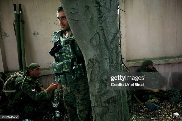 Georgian soldiers rest beside the road between Tskinvali and Gori, 20 km from the South Ossetian border on August 2008 near Gori, Georgia. After...