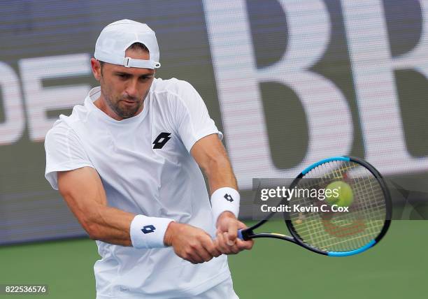 Tim Smyczek returns a backhand to Donald Young during the BB&T Atlanta Open at Atlantic Station on July 25, 2017 in Atlanta, Georgia.