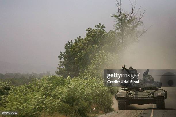 Georgian troops head towards Tskinvali from Gori, 20 km from the South Ossetian border on August 2008 near Gori, Georgia. After calling a ceasefire...