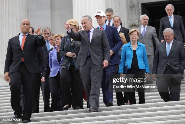 Senate Minority Leader Chuck Schumer leads Democratic members of the Senate to a press conference after Republicans successfully passed a key...