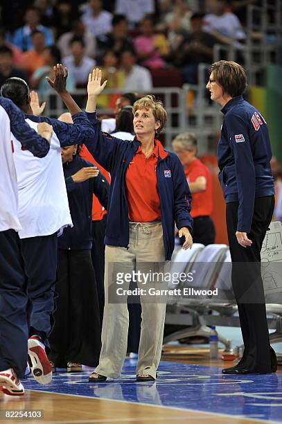 Assistant Coach Gail Goestenkors of the U.S. Women's Senior National Team high-fives the team during day 3 of the women's preliminary basketball game...
