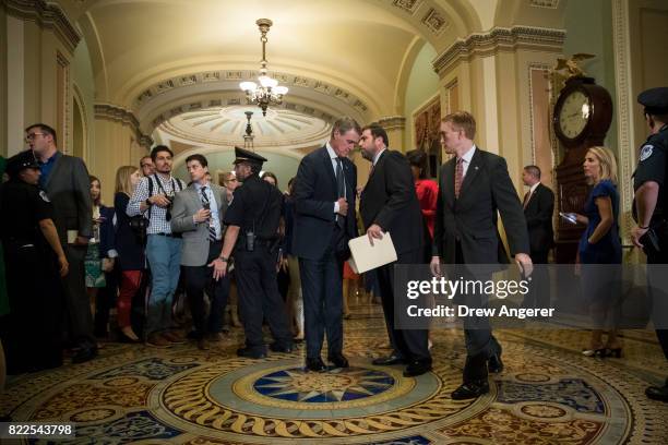 Sen. David Perdue , speaking with an aide, and Sen. James Lankford walk to the Senate floor for a procedural vote on the GOP heath care plan, on...