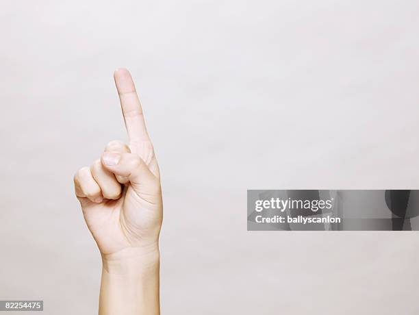 woman's hand with finger pointing up - hand pointing ストックフォトと画像