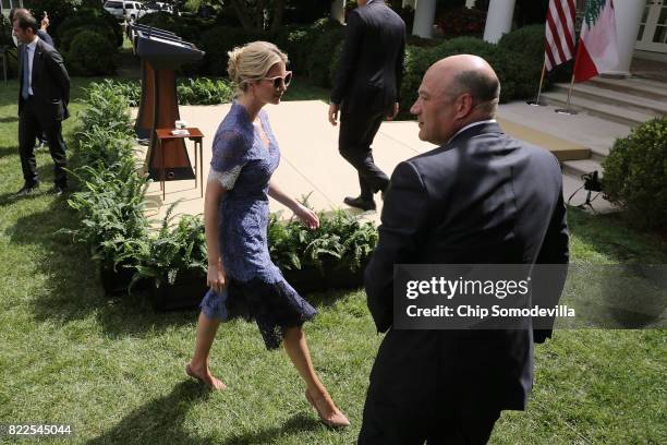 President Donald Trump's daughter Ivanka Trump walks past National Economic Council Director Gary Cohn as she leaves the Rose Garden following a news...