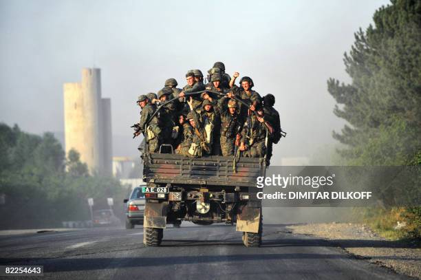 Georgian soldiers sit on a truck as they leave the town of Gori on August 11, 2008. Russia's defence ministry today denied a Georgian claim that...