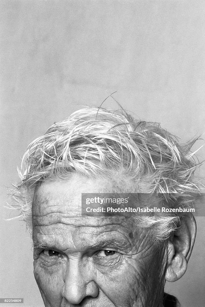 Senior man with messy hair, portrait, cropped