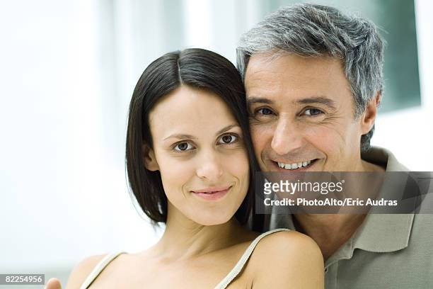 couple cheek to cheek, smiling at camera, portrait - age contrast stock pictures, royalty-free photos & images