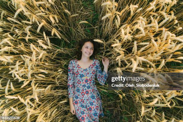 Woman laying on the  wheat field