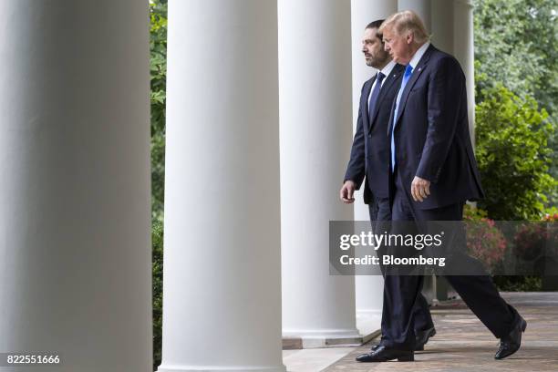 President Donald Trump, right, and Saad Hariri, Lebanon's prime minister, walk to a joint press conference in the Rose Garden of the White House in...