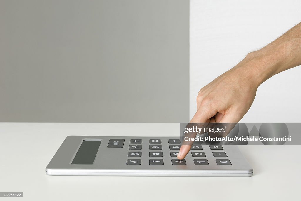 Hand using oversized calculator