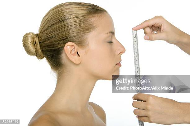 woman in profile, face being measured with ruler - mh stock pictures, royalty-free photos & images