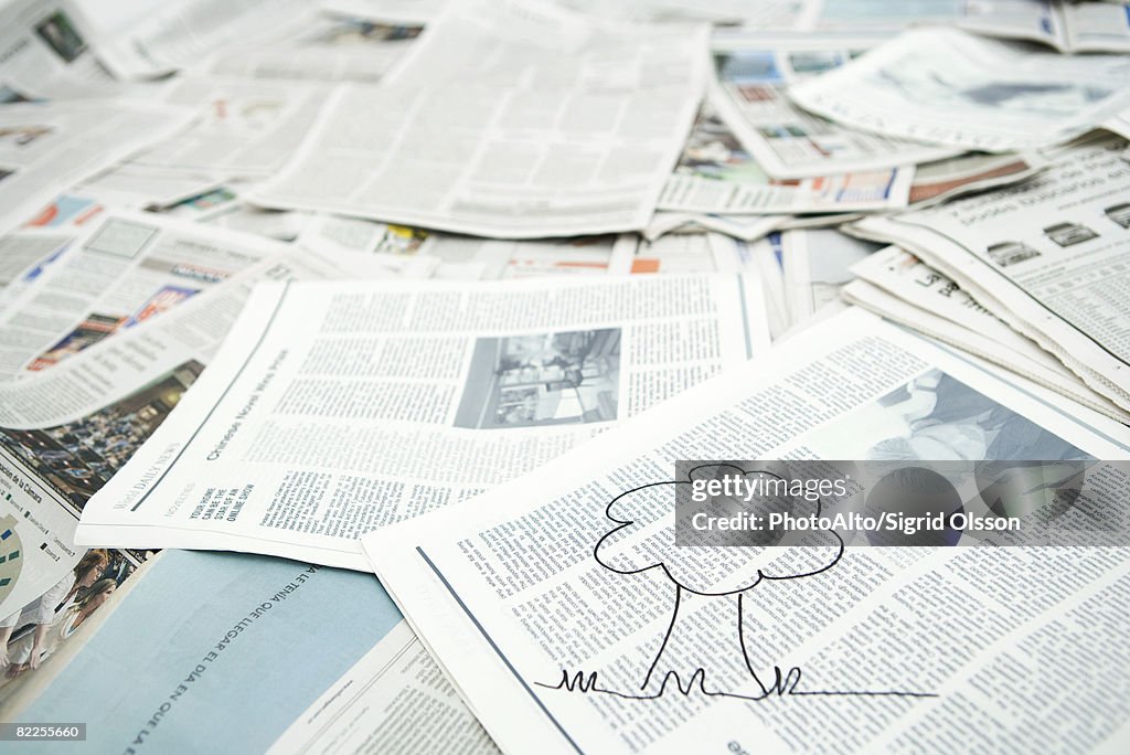 Drawing of tree on pile of newspaper