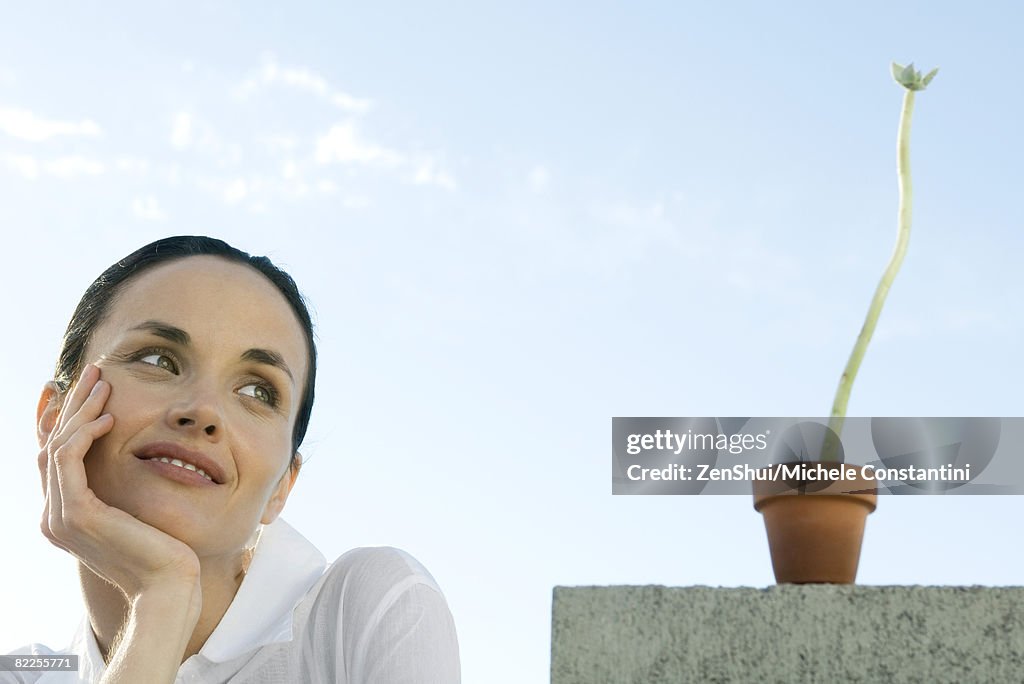 Woman with plant, smiling