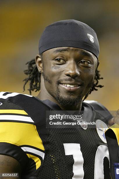 Wide receiver Santonio Holmes of the Pittsburgh Steelers smiles as he looks on from the sideline during a preseason game against the Philadelphia...