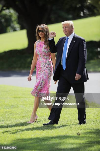 President Donald Trump and first lady Melania Trump walk across the South Lawn before departing the White House July 25, 2017 in Washington, DC....