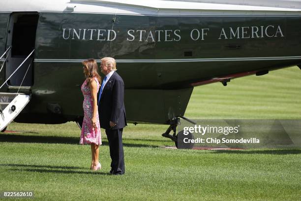 President Donald Trump and first lady Melania Trump pause on the South Lawn before departing the White House July 25, 2017 in Washington, DC. Trump...