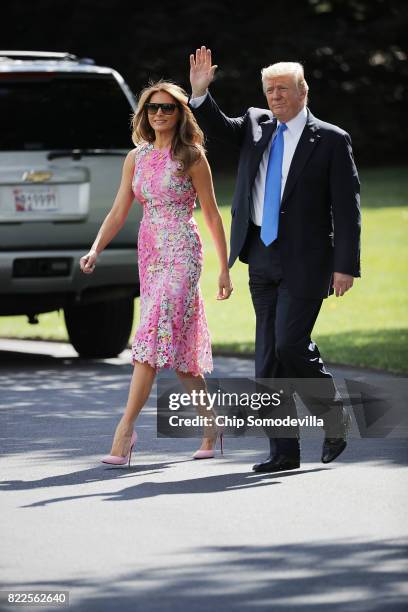 President Donald Trump and first lady Melania Trump walk across the South Lawn before departing the White House July 25, 2017 in Washington, DC....