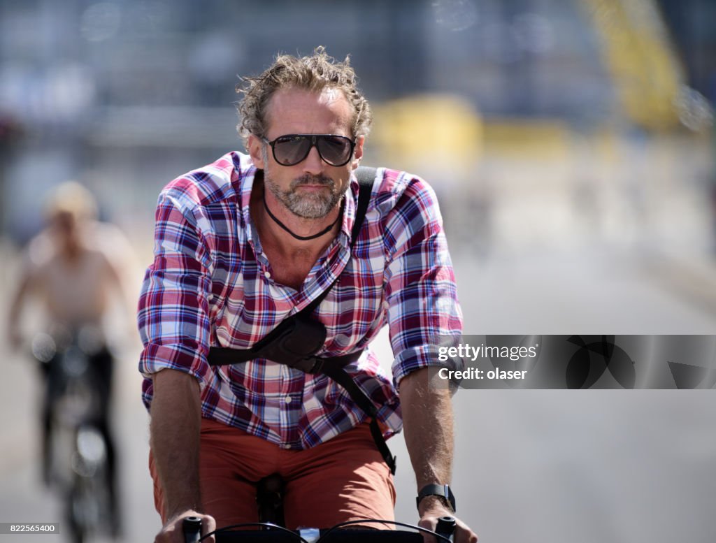 Man biking in traffic