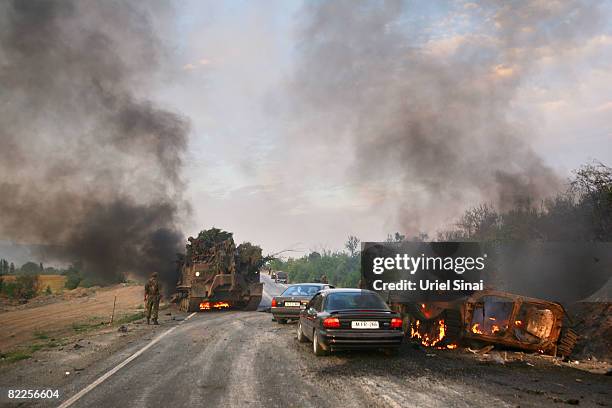 Georgian soldier walks away from a burning armoured vehicle on the road to Tbilisi on August 11, 2008 outside Gori, Georgia. Russia called today for...