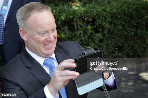 Outgoing White House Press Secretary Sean Spicer takes photographs for friends before President Donald Trump departs the White House July 25, 2017 in...