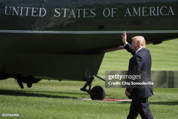 President Donald Trump waves to guests while walking across the South Lawn before departing the White House July 25, 2017 in Washington, DC. Trump is...